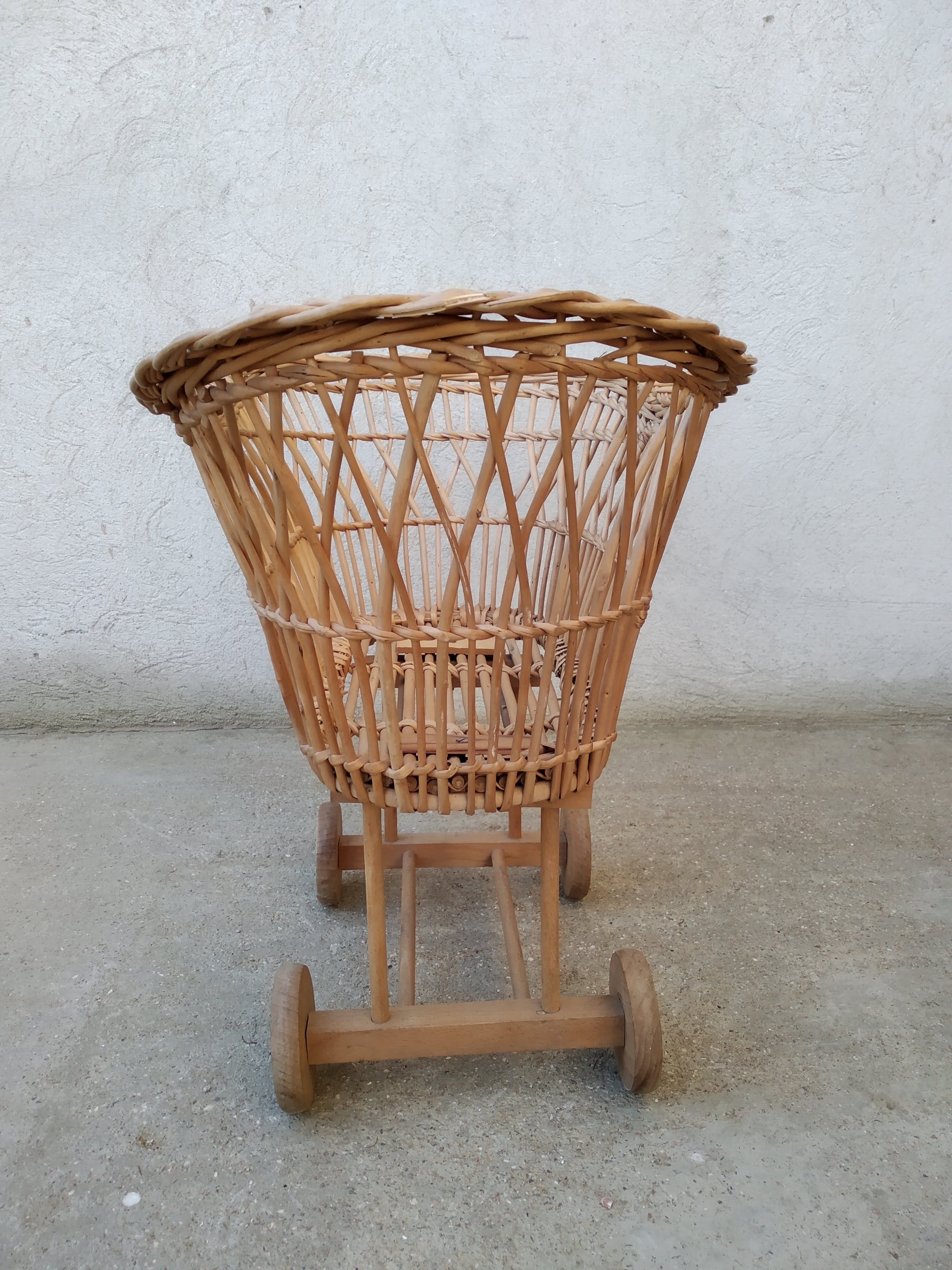Rattan cradle for doll on vintage wheels