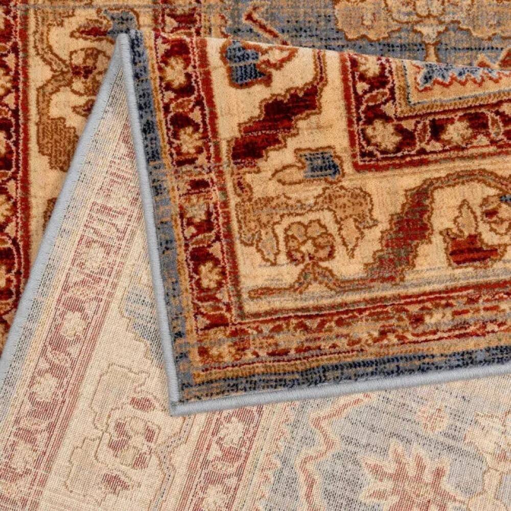 Oriental rug in beige, blue, and red wool.