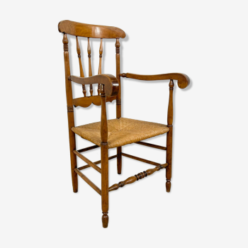 Antique oak and elm wooden armchair with cane seat