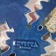 Blue cast iron trivet with flowers, small chip in the paint otherwise very good.