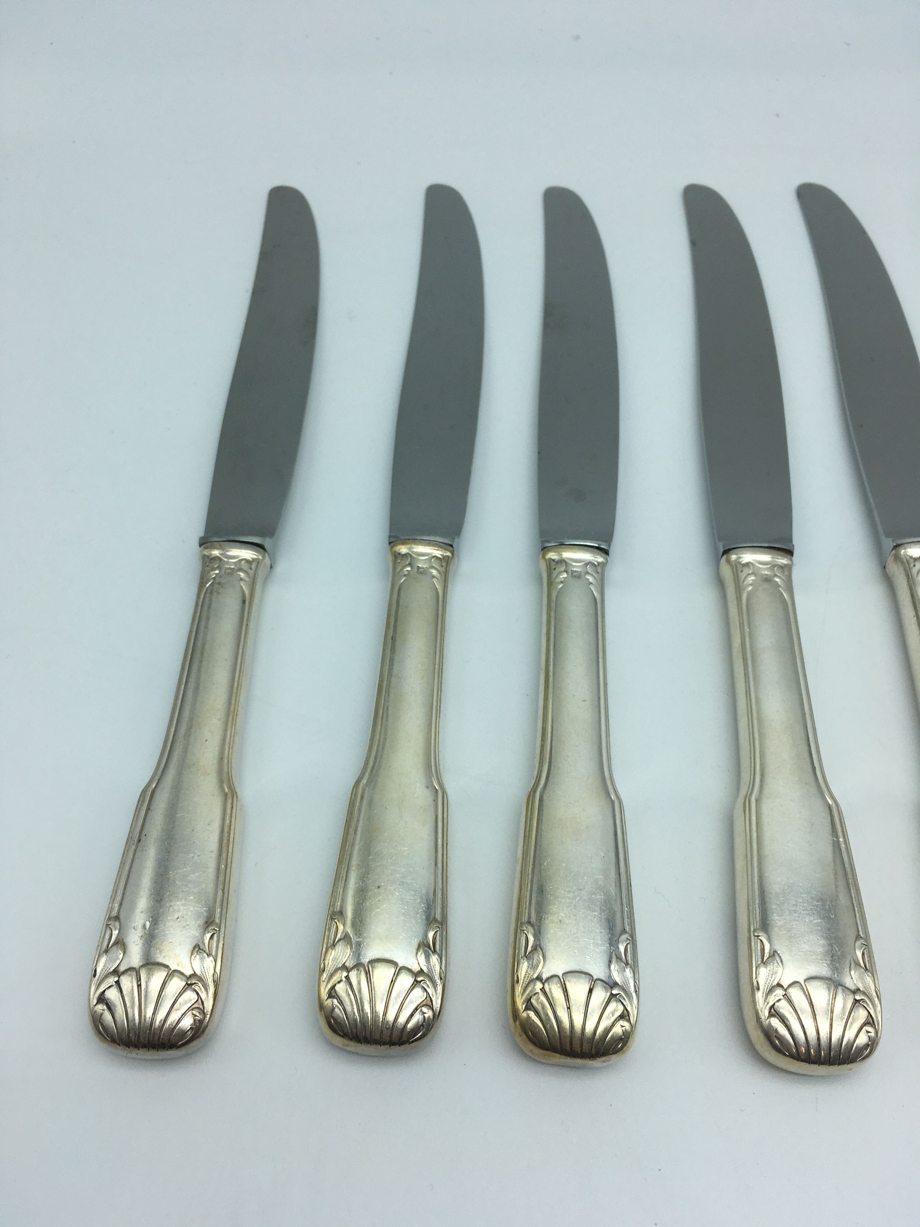 12 silver metal knives.