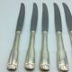 12 silver metal knives.