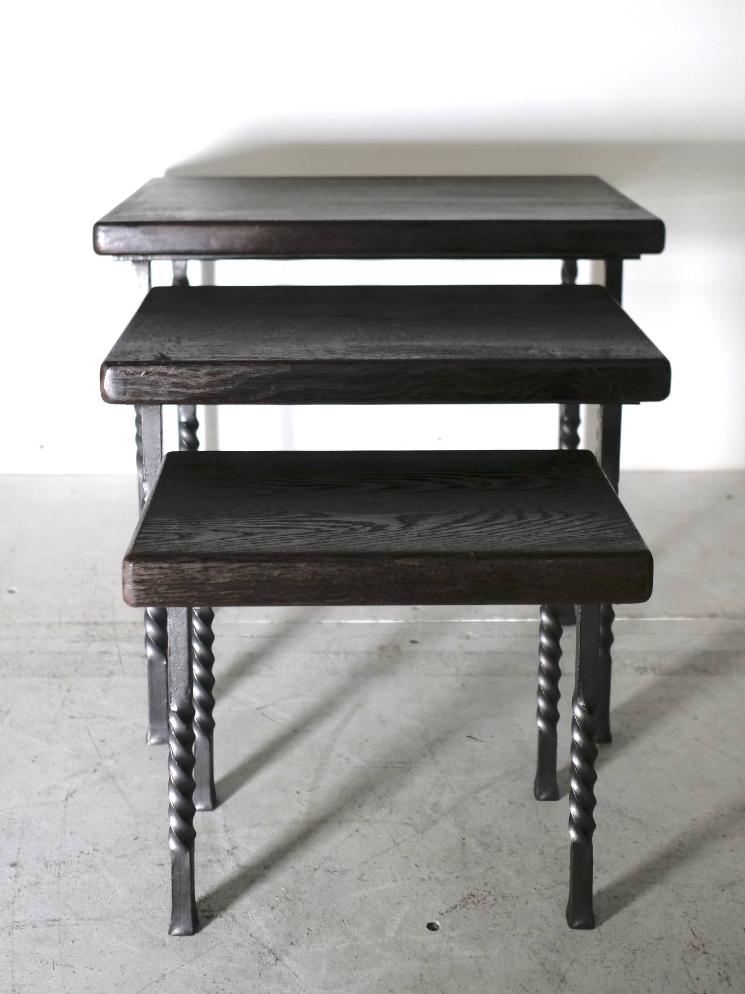 Brutalist nesting table in ebonized oak and wrought iron