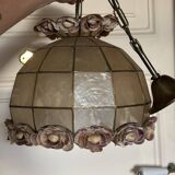 Vintage pendant light with a pearlescent shade and floral decoration.