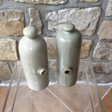 Lot of two old bottles of beige enamelled sandstone bottles