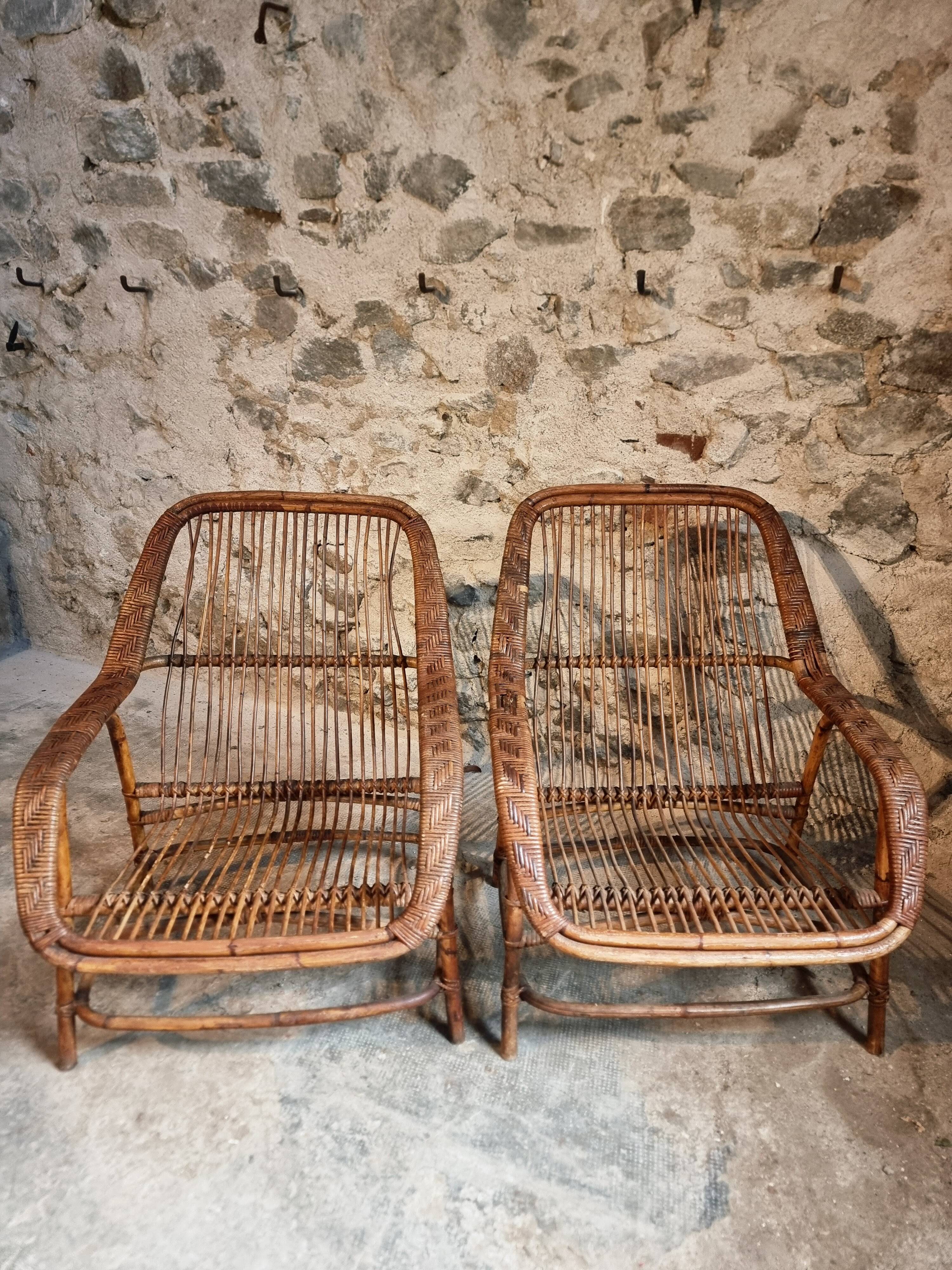 Vintage rattan lounge set, French wicker armchairs and round table, circa 1930–1950.