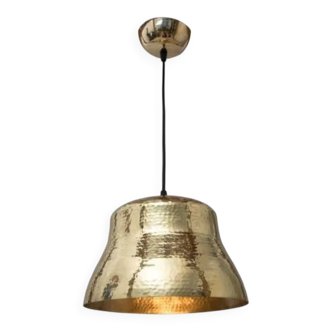 Industrial pendant lamp in the shape of a hammered copper bell.