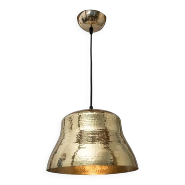 Industrial pendant lamp in the shape of a hammered copper bell.
