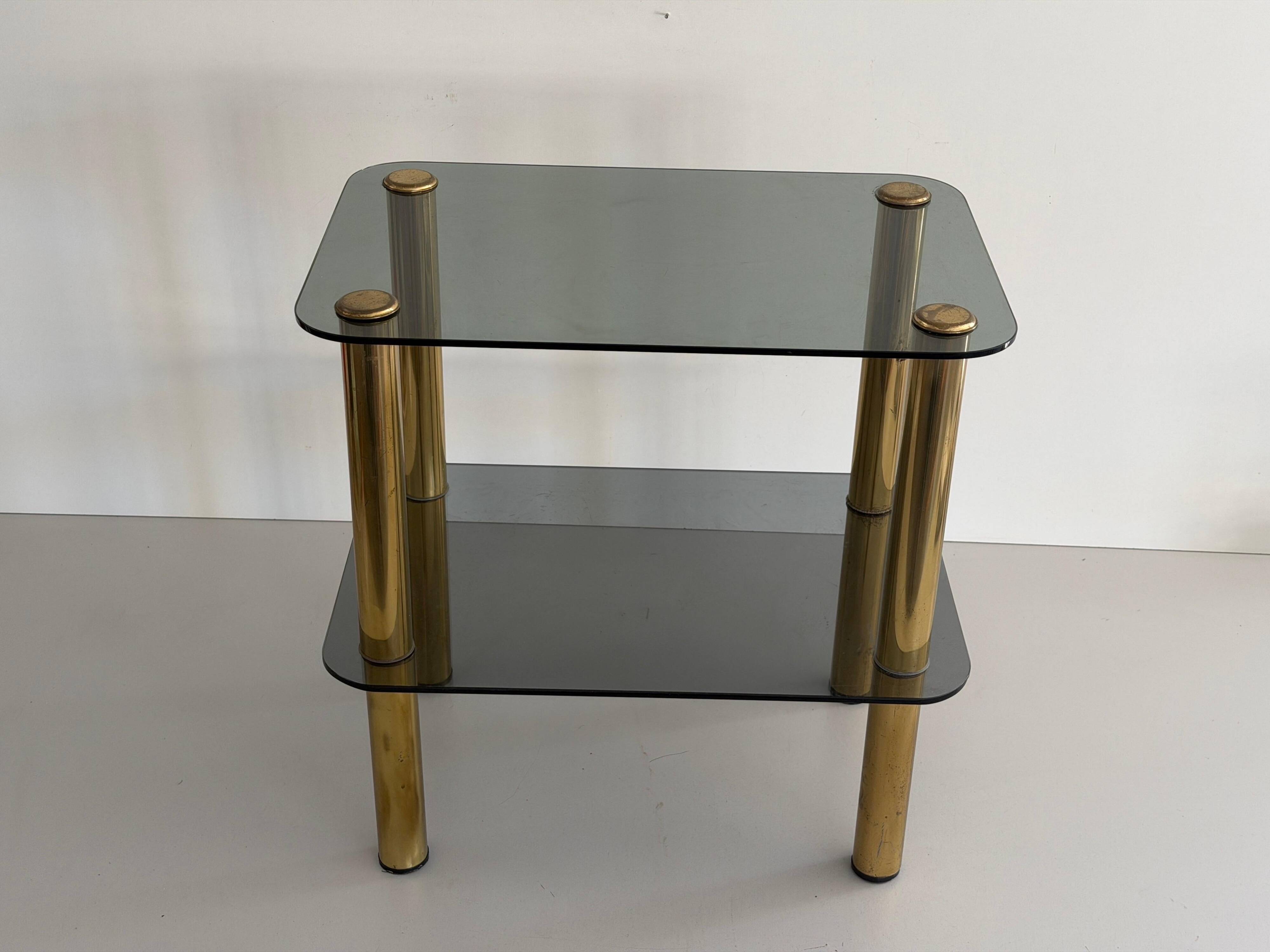 Side table in thick greenish glass with brass legs, Italy, 1960s.