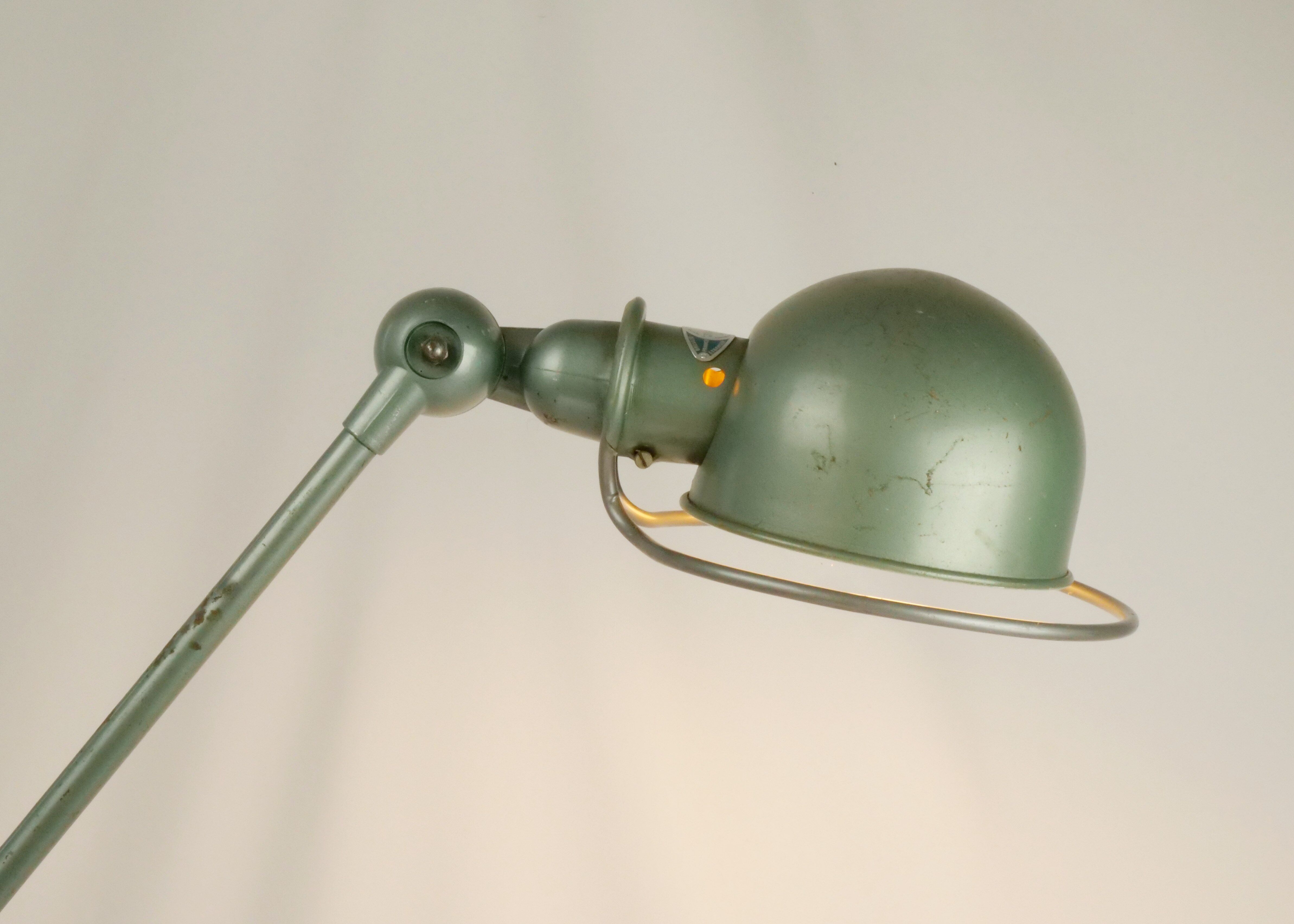 Jielde table lamp with 2 arms on a wooden base.