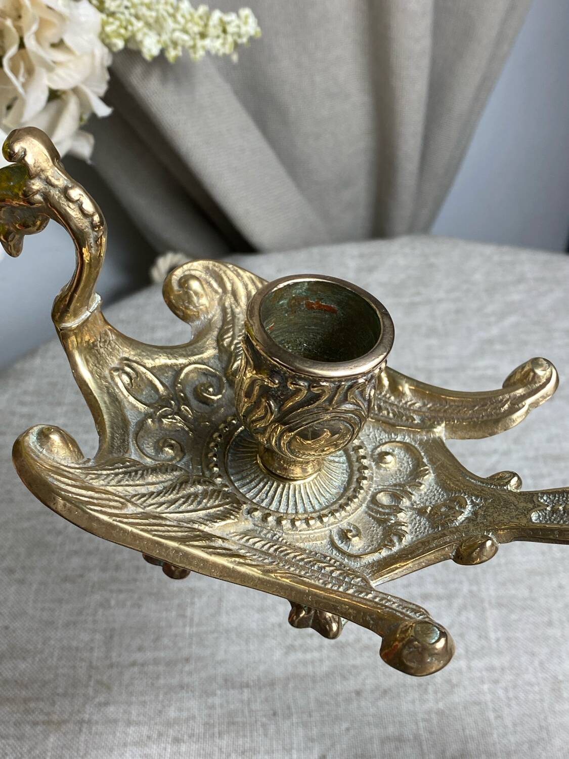 Bronze hand candlestick in the shape of a peacock