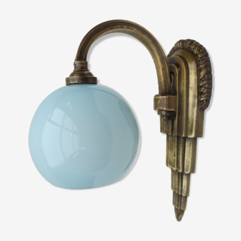Art deco wall lamp in brass and soft blue opaline globe
