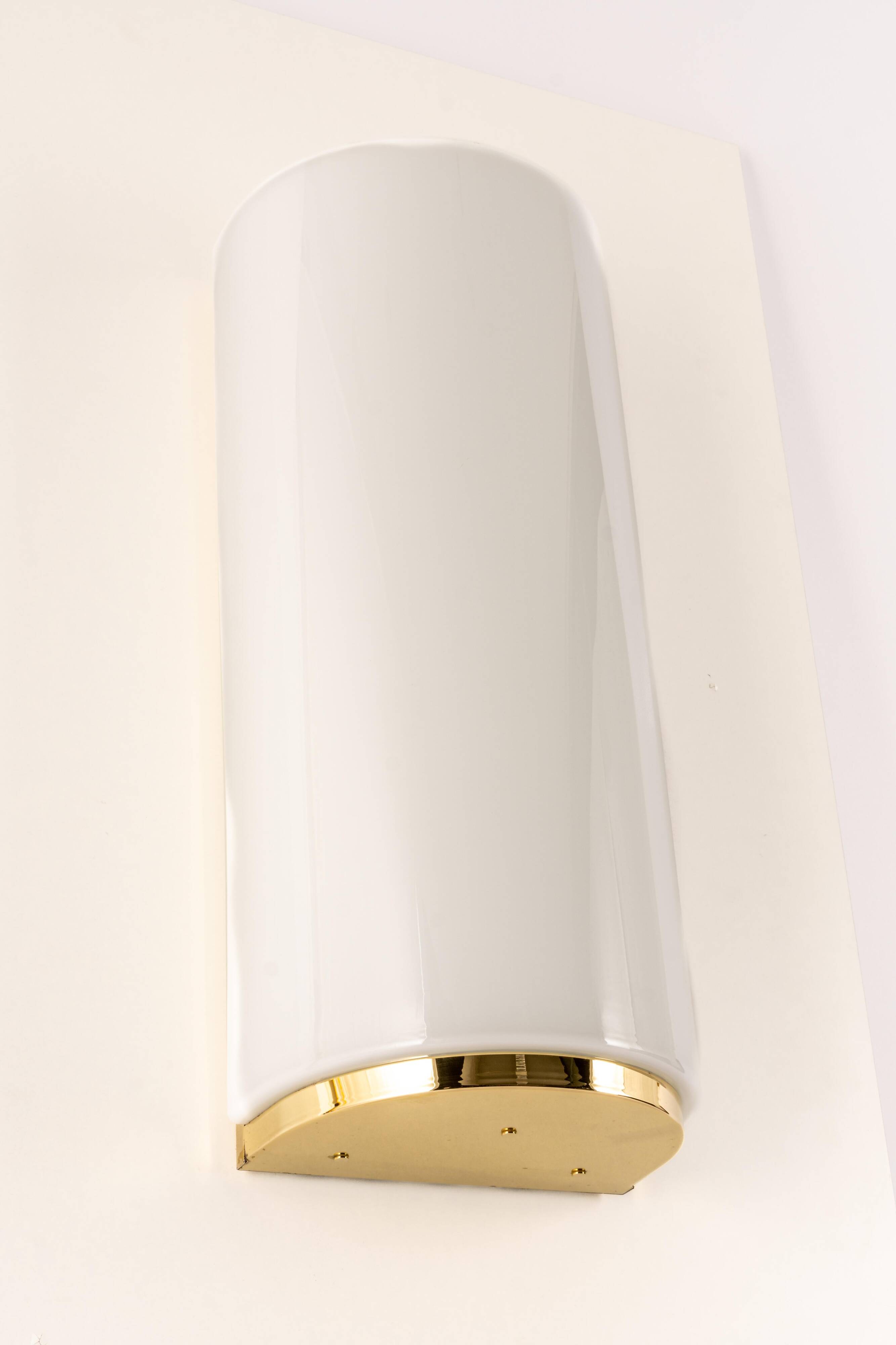 Pair of large opaline glass wall lights in brass designed by Limburg, Germany.