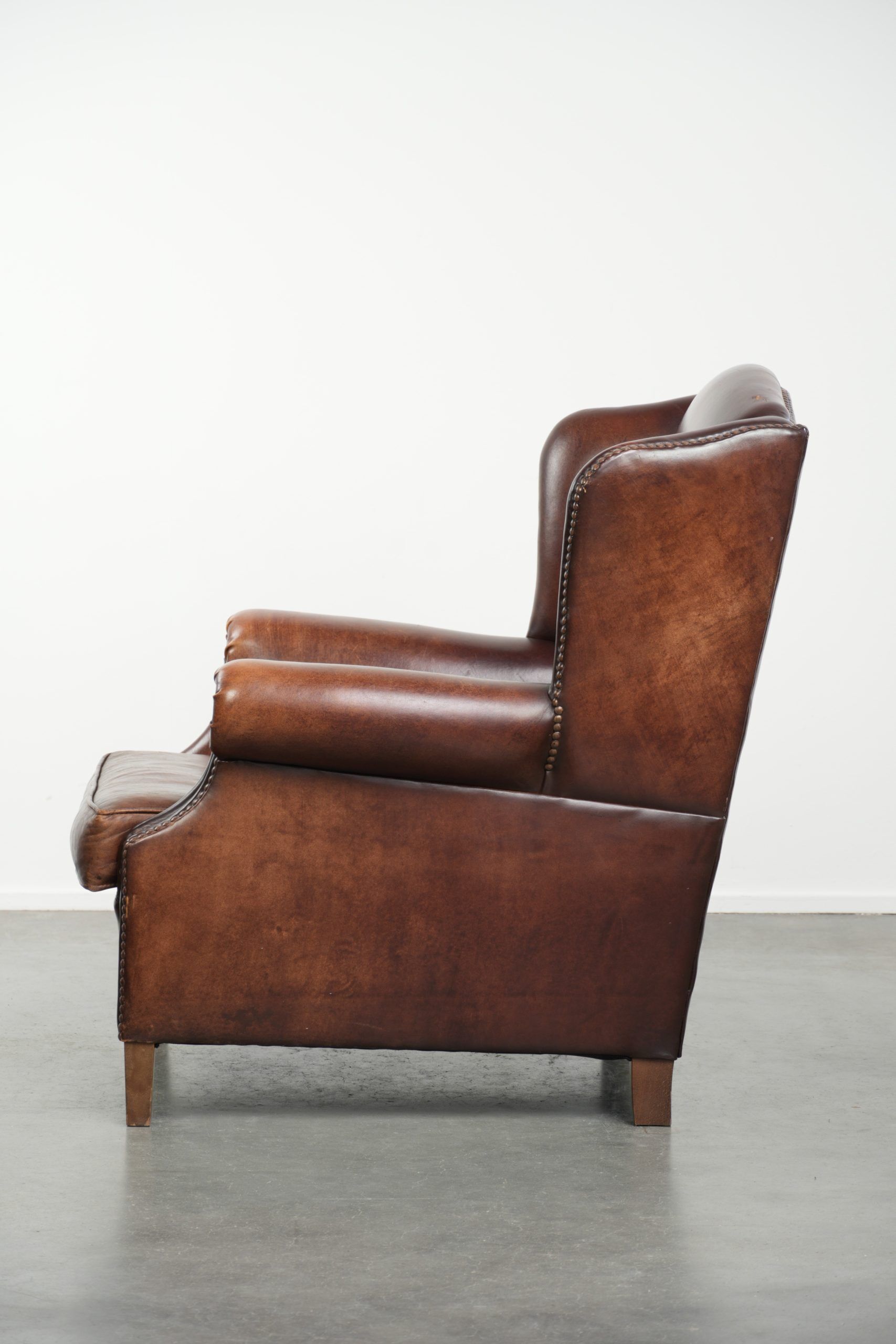Vintage sheepskin wingback armchair with a timeless English look