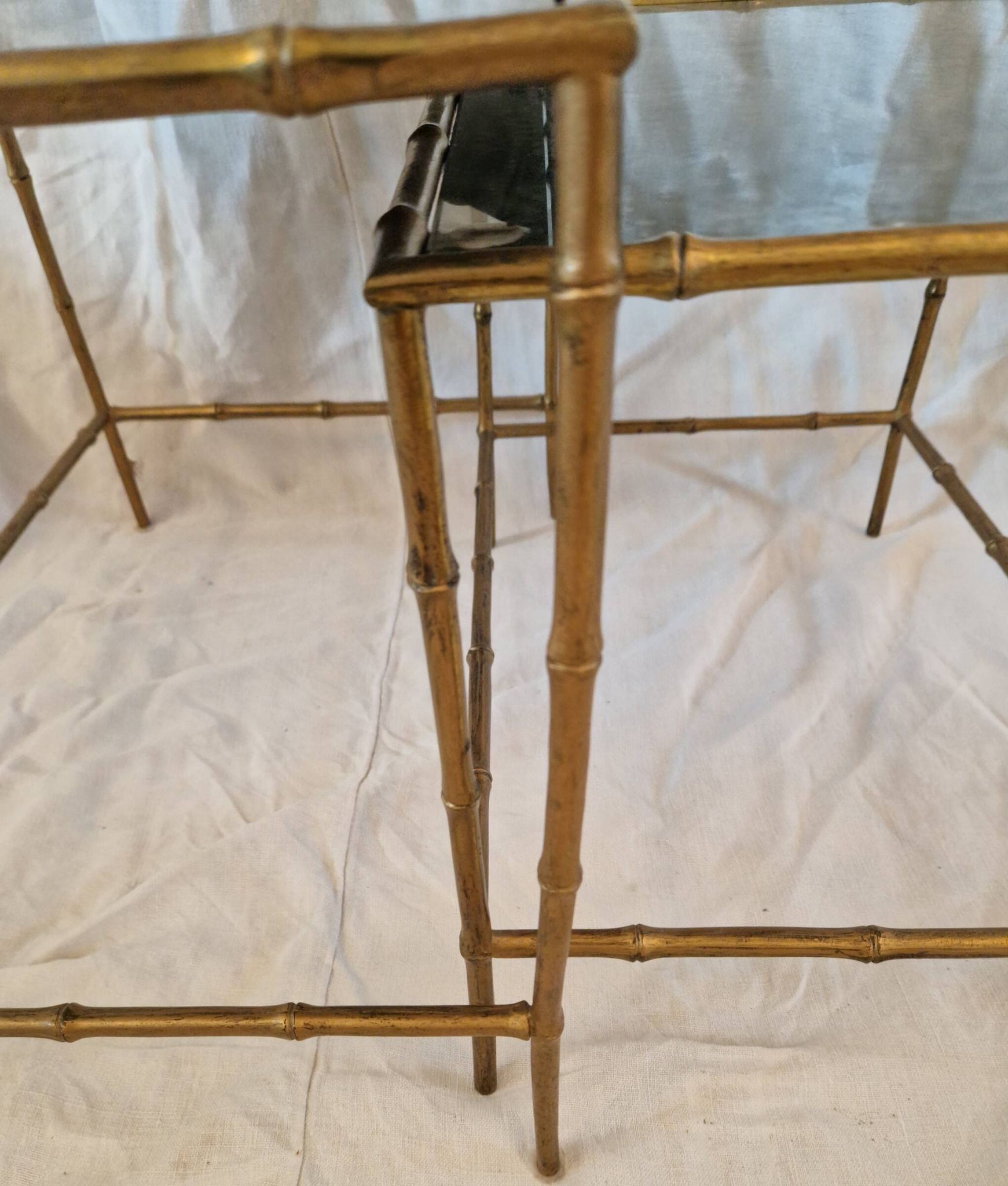 Pair of vintage nesting tables in faux bamboo with a gold finish – distressed mirrors