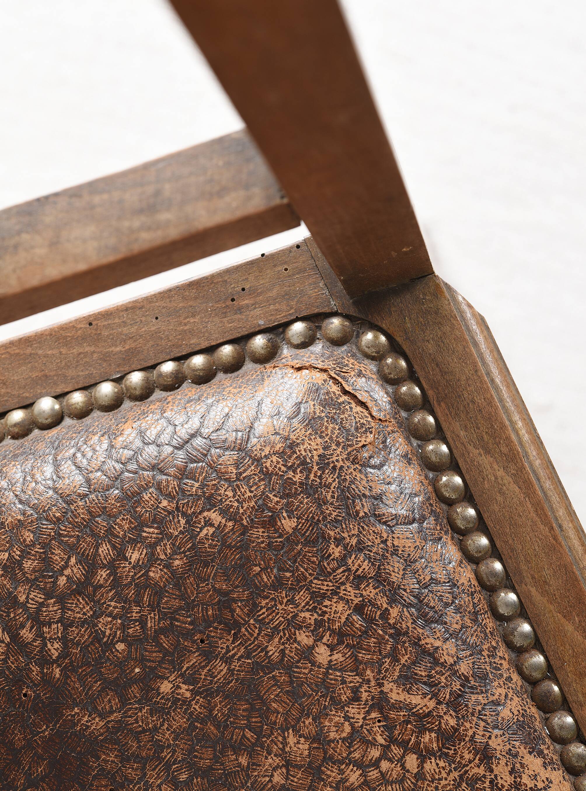 Art Deco style chair in carved wood and leather.