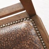 Art Deco style chair in carved wood and leather.