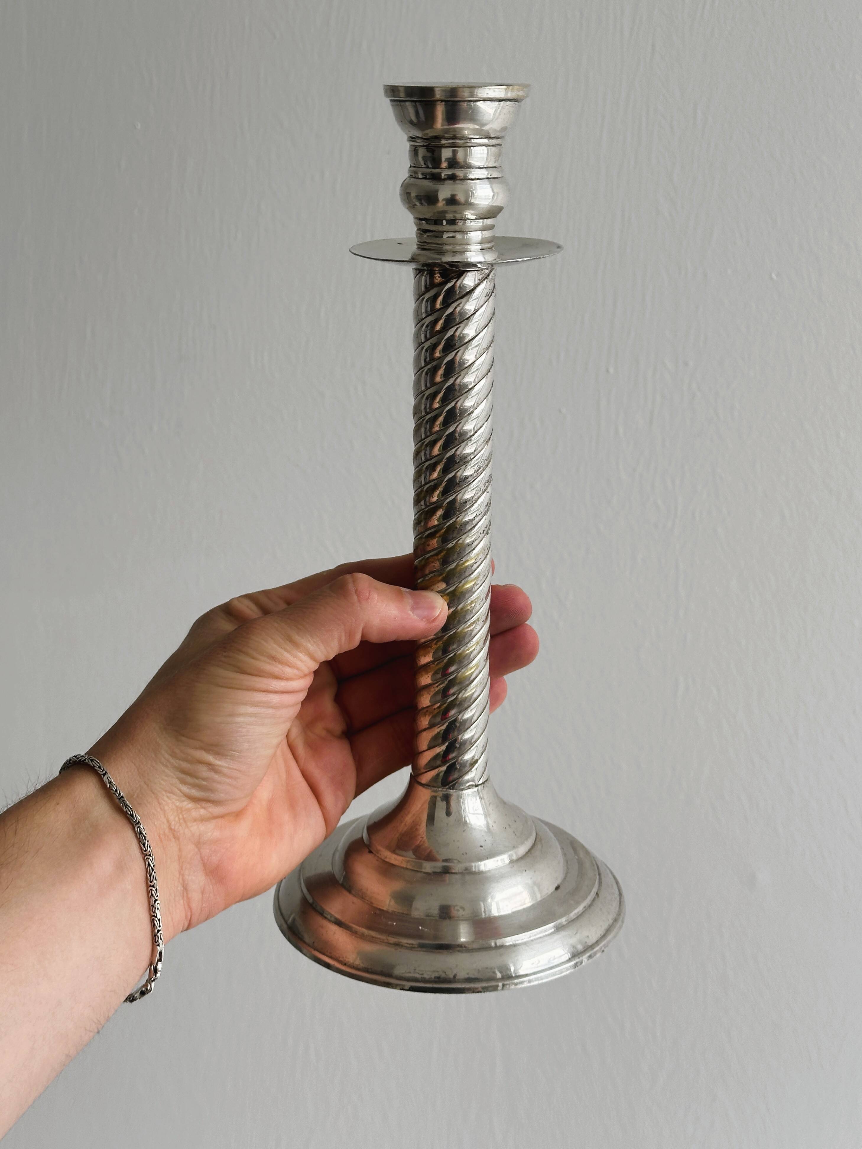 Patinated silver-plated metal candlesticks