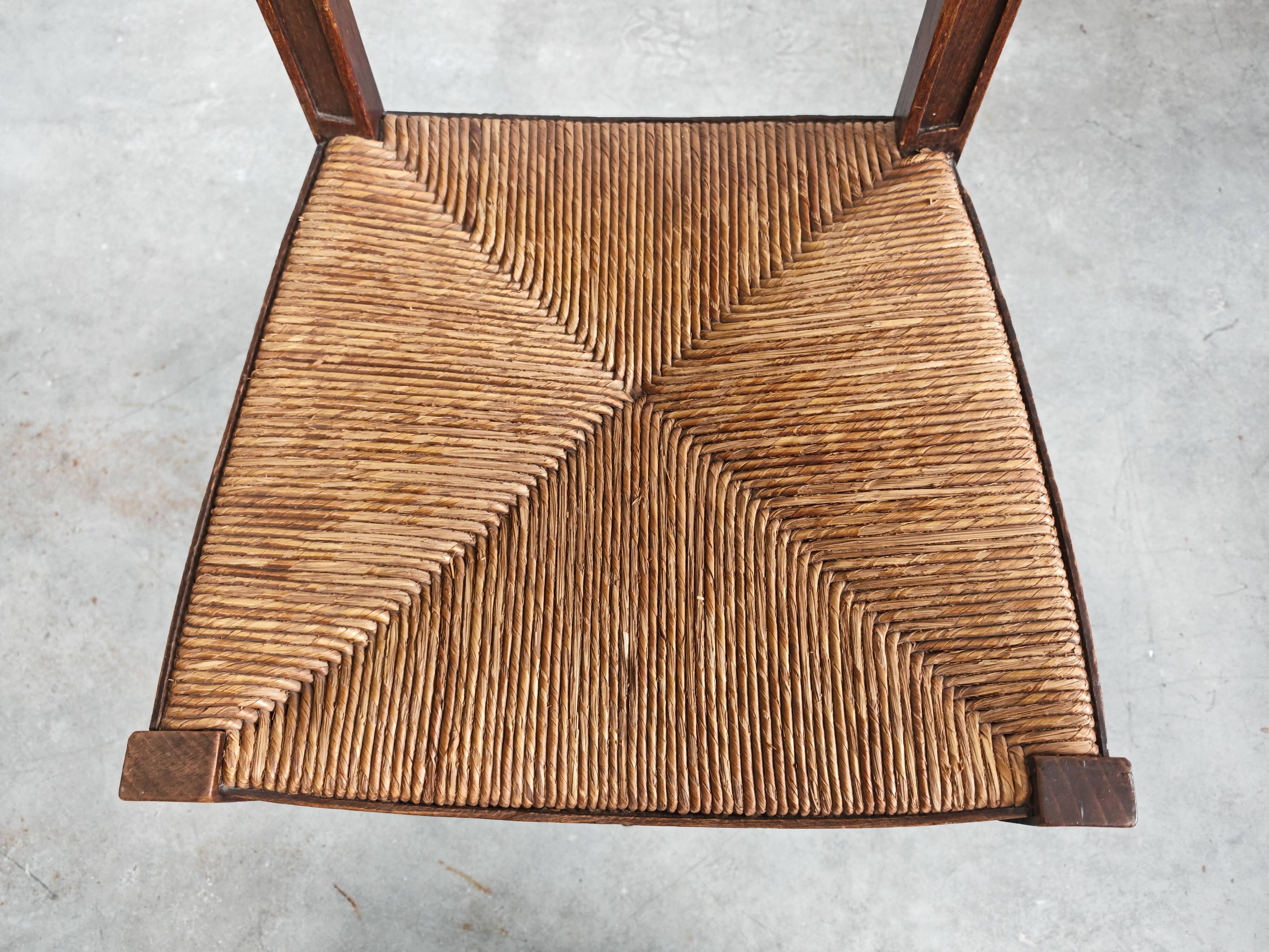 Pair of Neo-Renaissance oak chairs with straw seats, 1910