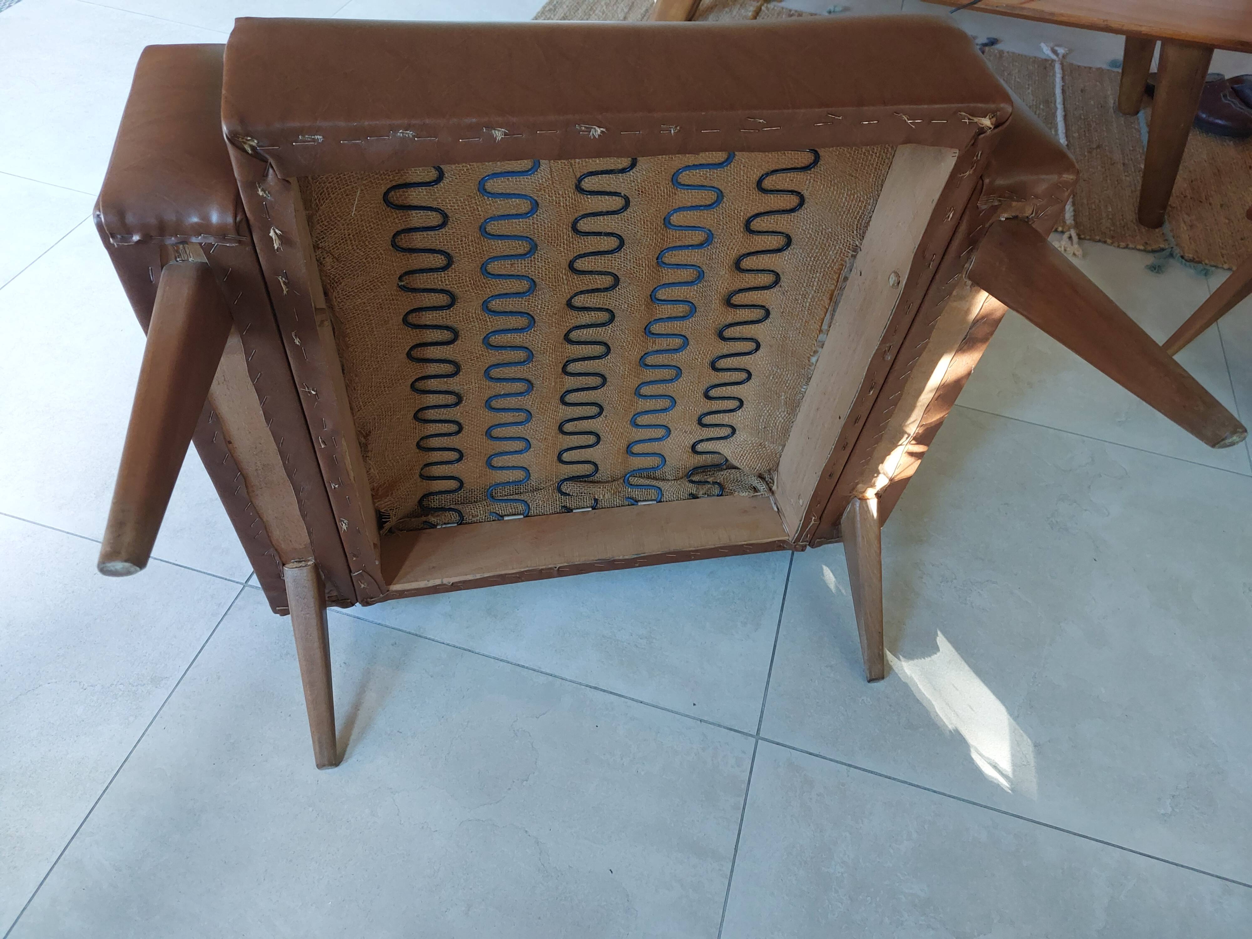 a pair of comfortable vintage armchairs with splayed legs