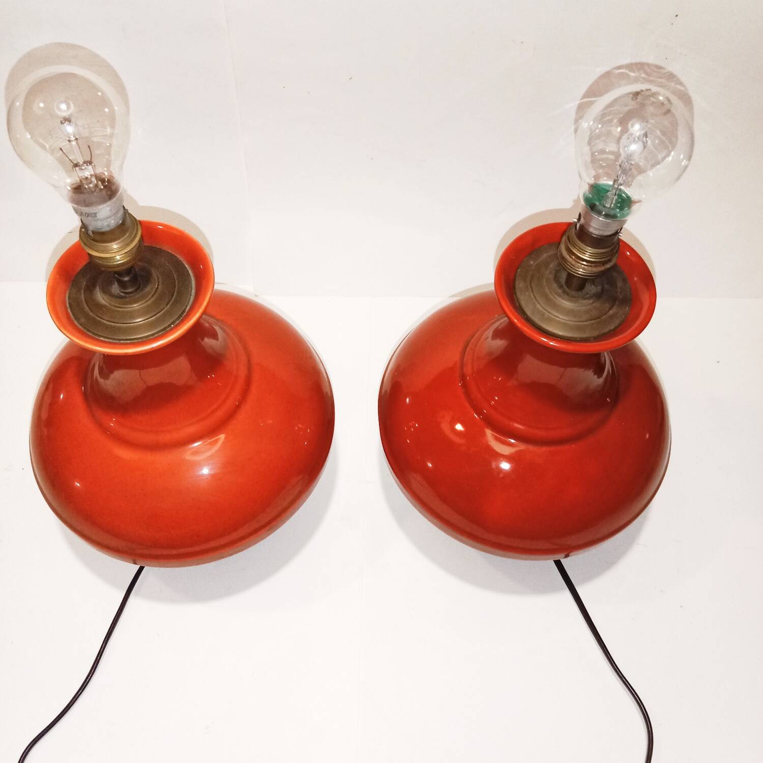 Pair of ceramic lamp bases in the shape of orange gourds.
