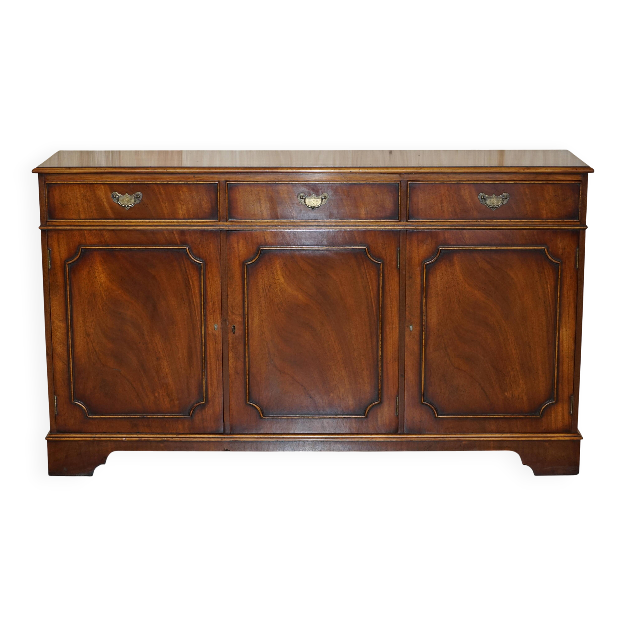 Vintage mahogany buffet with three drawers and shelves.