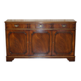 Vintage mahogany buffet with three drawers and shelves.