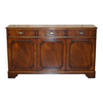 Vintage mahogany buffet with three drawers and shelves.