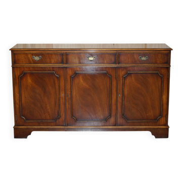 Vintage mahogany buffet with three drawers and shelves.