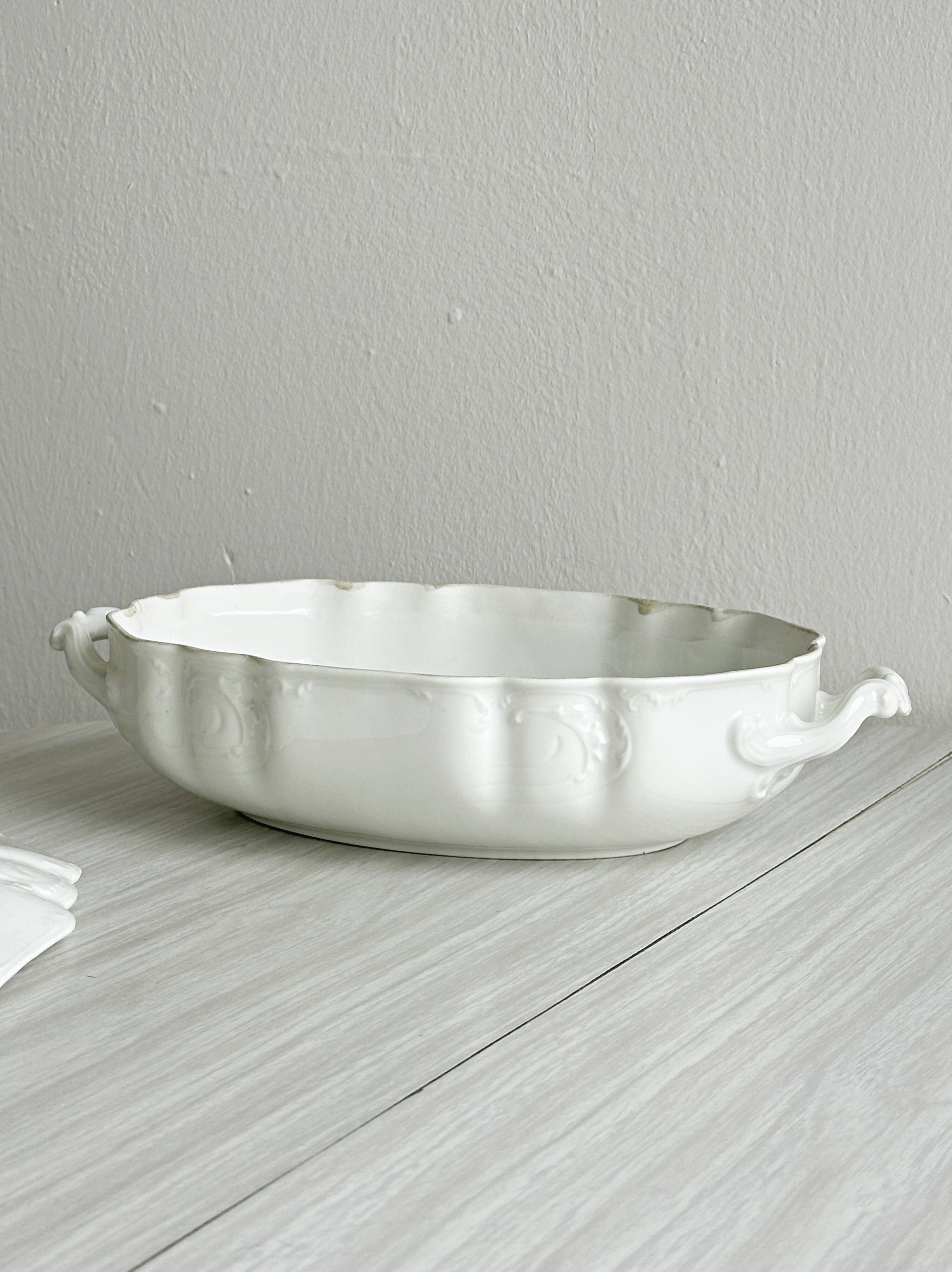 White fine porcelain soup tureen with relief decoration.