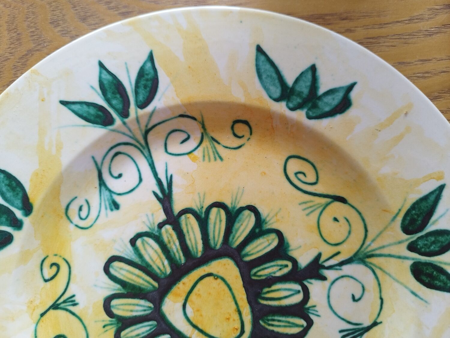 Plate decorated with yellow and green flower, signed Kerbigot.