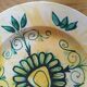 Plate decorated with yellow and green flower, signed Kerbigot.