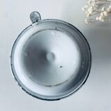 Old candle holder in white enameled metal