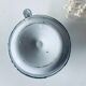 Old candle holder in white enameled metal