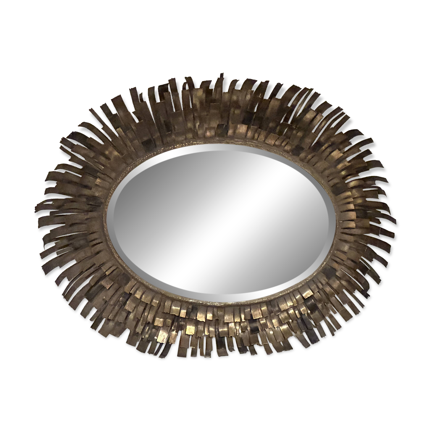 Large oval sun mirror in patinated gold metal.