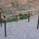 Golden and iridescent metal desk with a glass top from the 70s/80s.