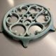 Old cast iron trivety turquoise