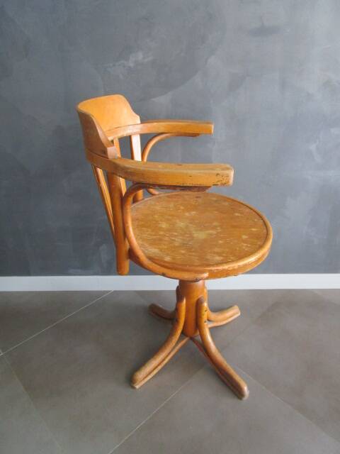 Old swivel office armchair in curved wood