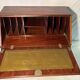 Antique mahogany secretary, upholstered flap and interior storage