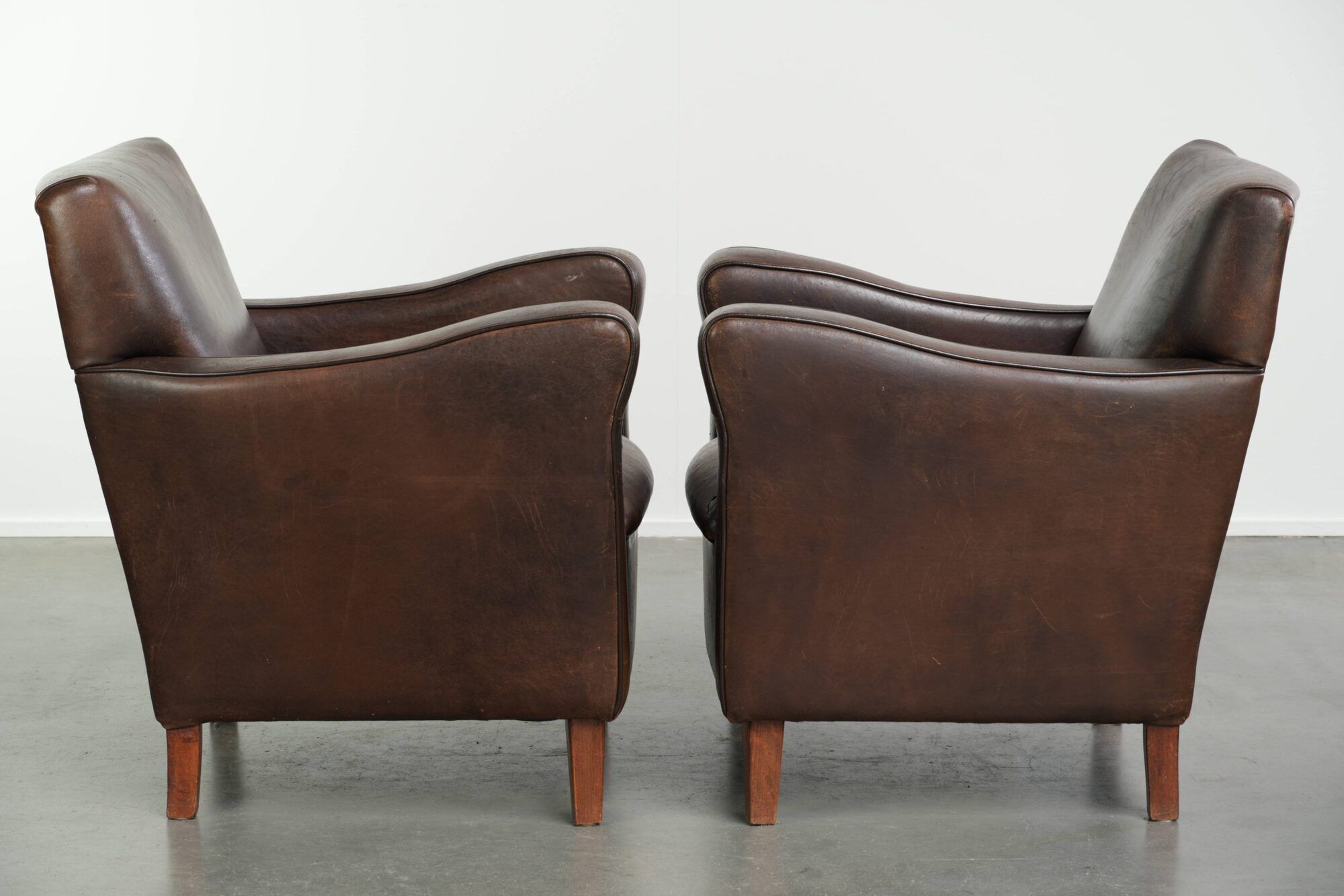 Sturdy set of vintage sheepskin armchairs in a beautiful dark colour