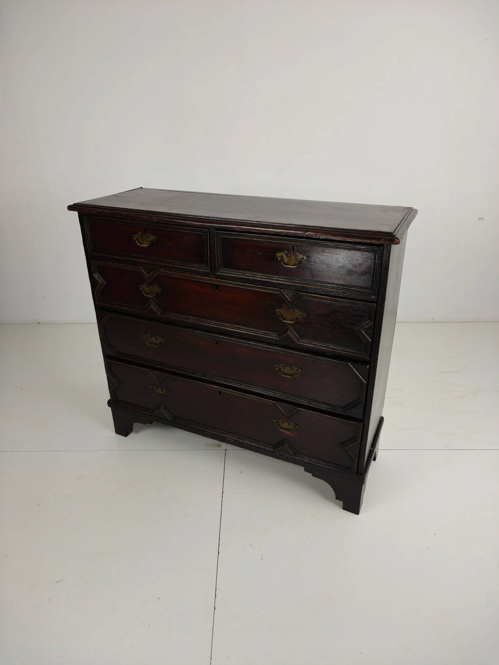 English geometric-panelled oak chest of drawers, circa 1680