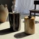 Black petrified wood side table with beige stripes and a semicircular shape.