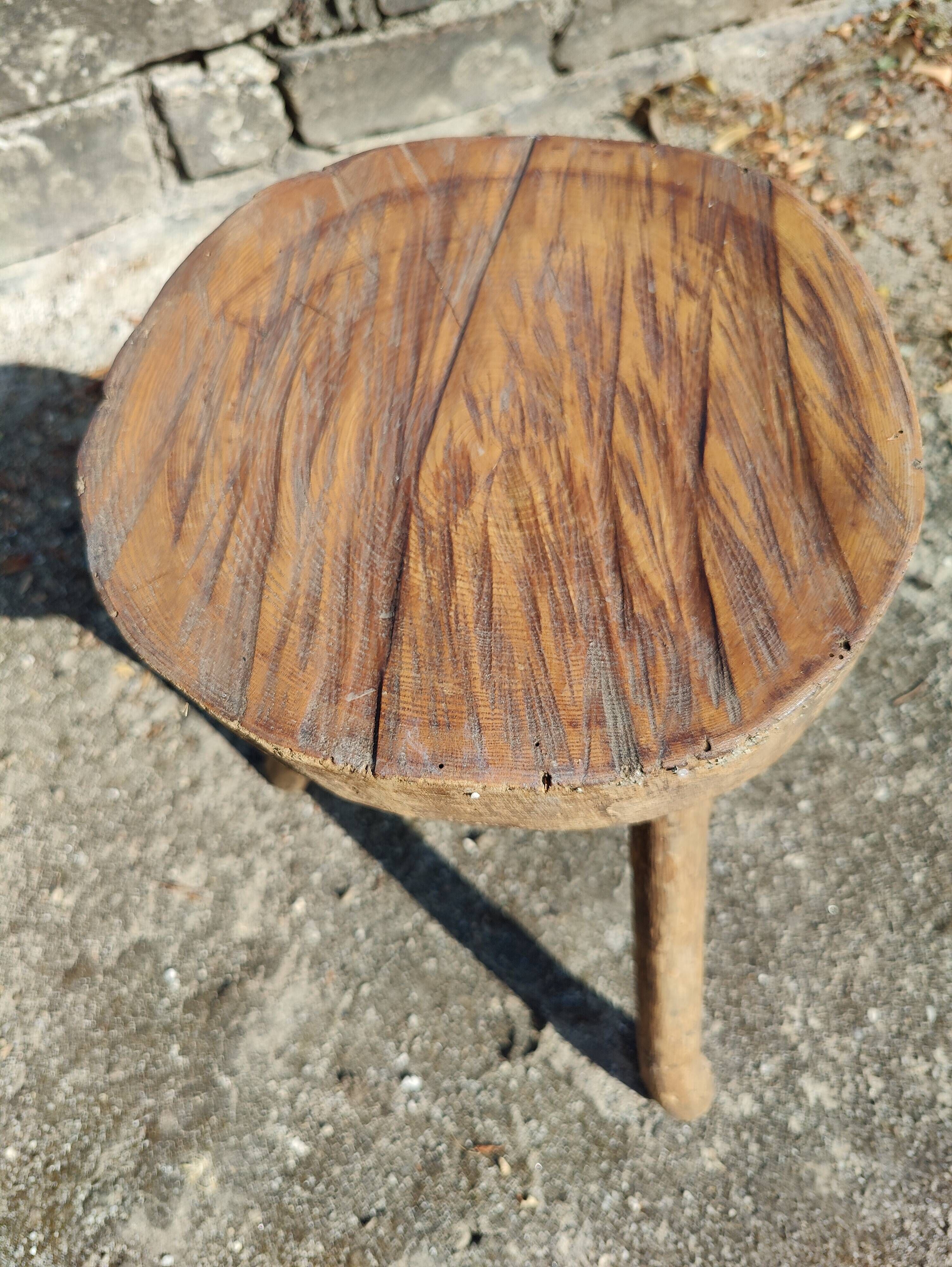 Rustic three-legged stool in minimalist wood in the style of Touret.