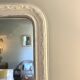 Antique Louis-Philippe mirror with pearls and shells, white patina.