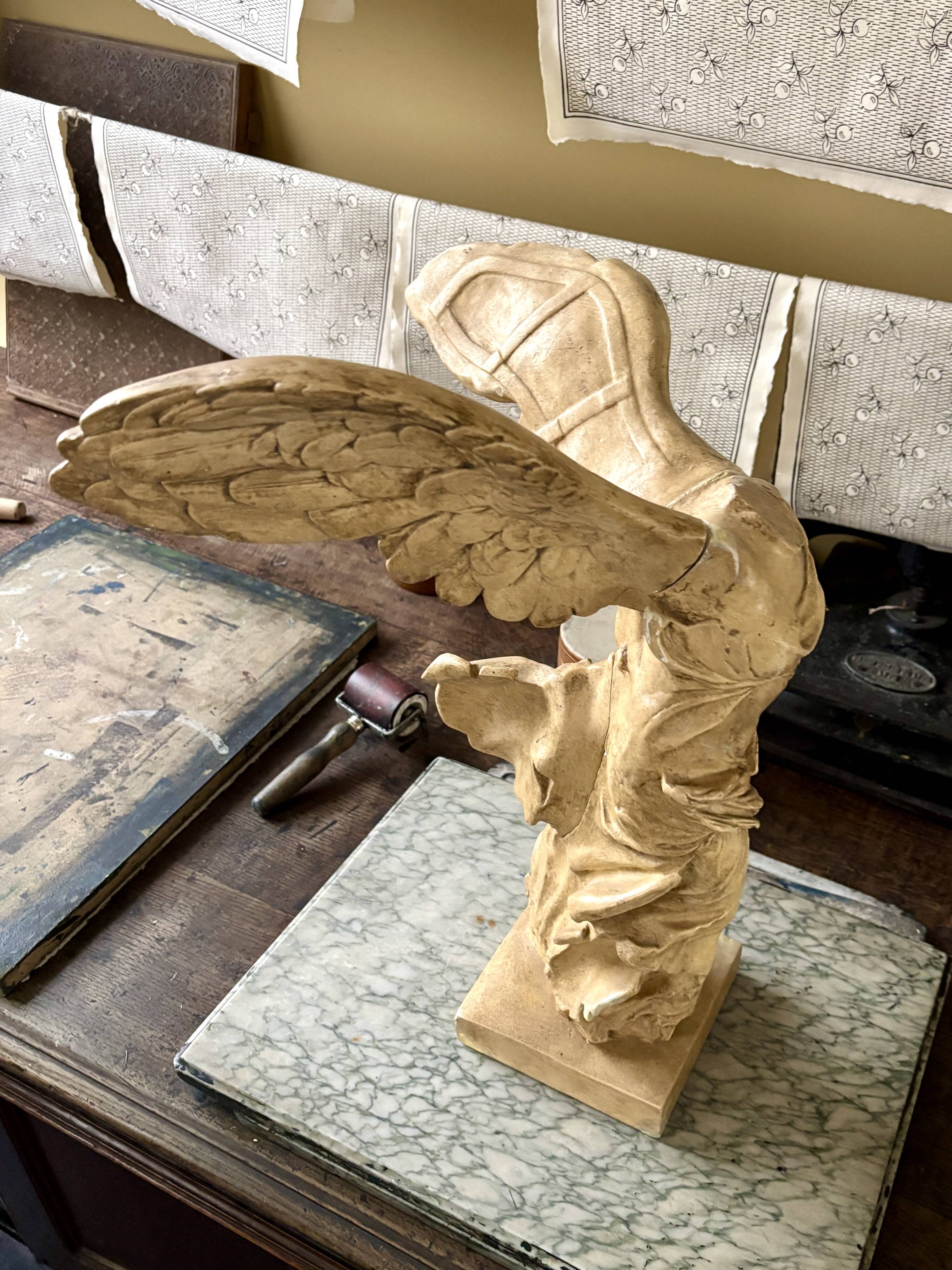 "Winged Victory of Samothrace", beige plaster statuette