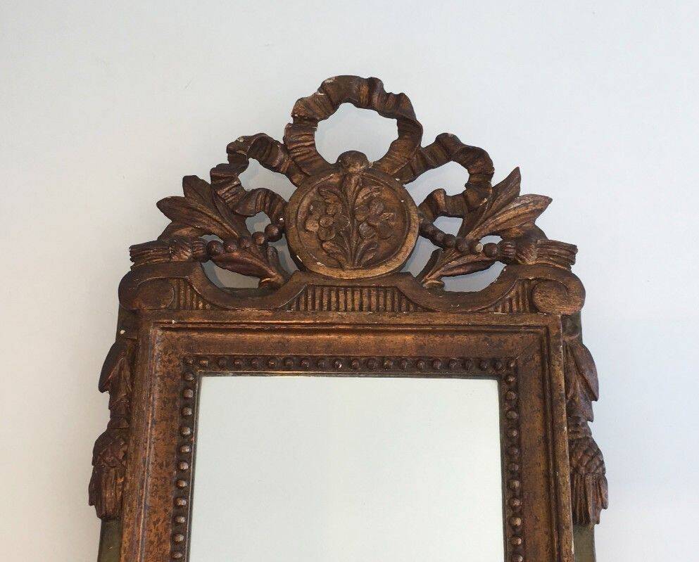 Louis XVI style mirror in patinated and gilded wood