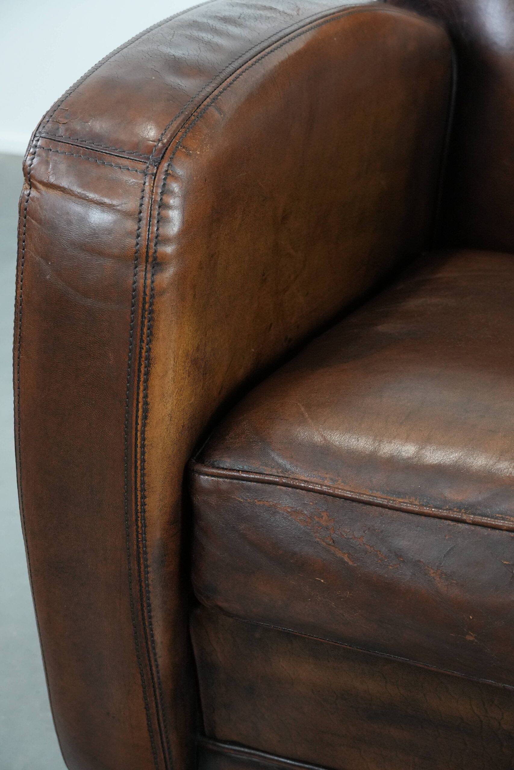 Characterful vintage sheepskin leather armchair with beautiful colours