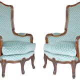 Pair of Louis XV style wingback armchairs with five legs.