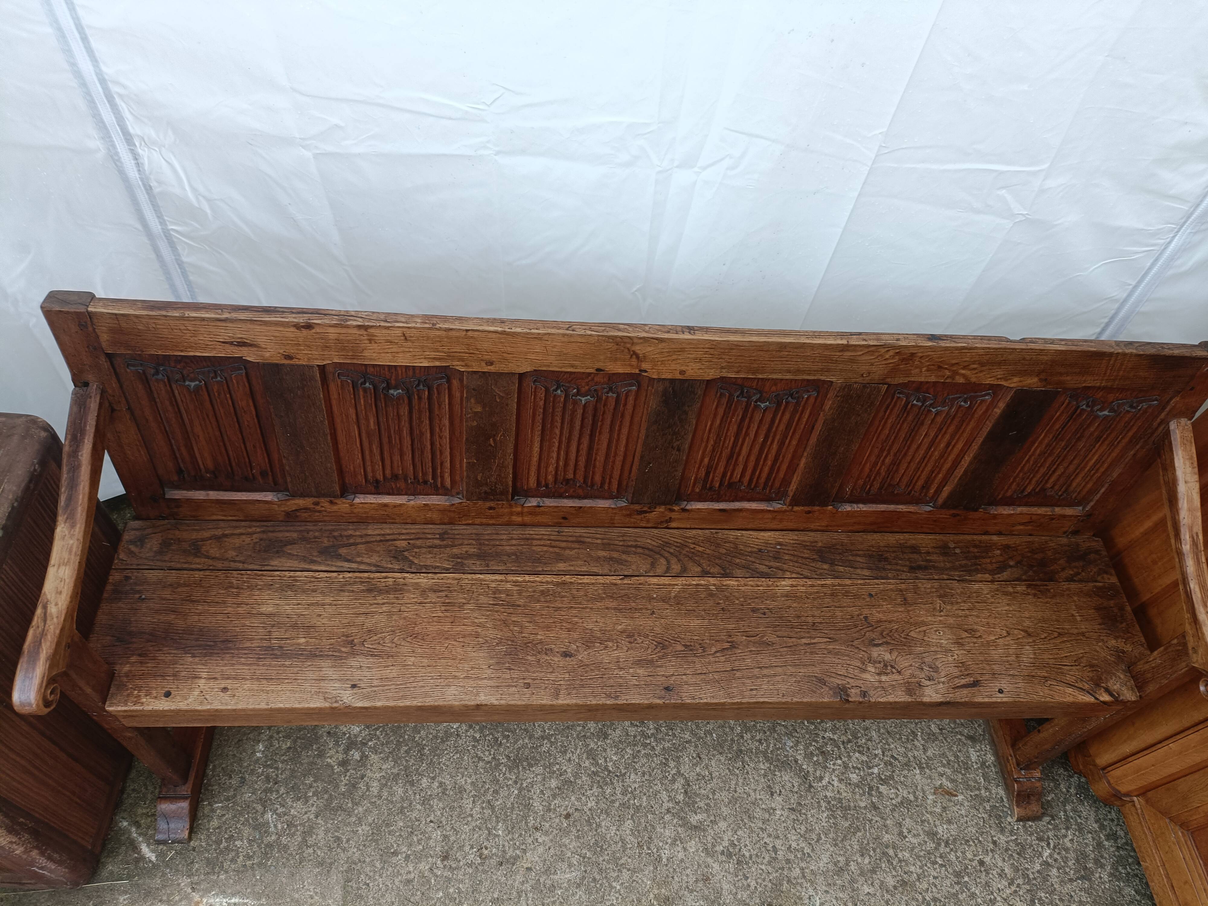 Oak church bench period XVII th century, back decorated with carved parchments