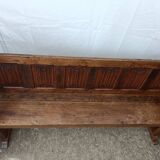 Oak church bench period XVII th century, back decorated with carved parchments